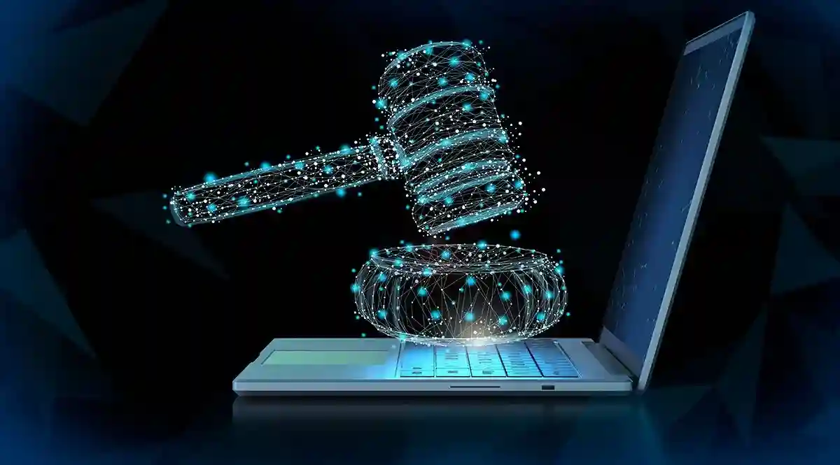 A digital illustration of a glowing gavel made of connected nodes hovering above a laptop, symbolizing the integration of compliance capabilities into digital and legal processes.