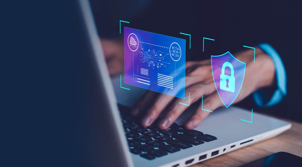 close up of a hand on top of a laptop keyboard accessing cyber risk management tool